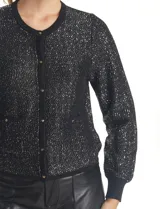 Cardigan negro de manga larga con lentejuelas bordadas, cuello redondo y cierre frontal con botones metálicos. Presenta puños y bordes acanalados.