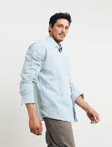 Camisa sport de manga larga con cuello buttondown, confeccionada en una mezcla de algodón y lino. Presenta un diseño clásico en color celeste con cierre frontal de botones.