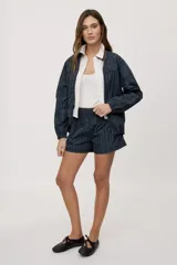 Campera liviana de calce relajado con estampado a cuadros en tonos de azul y verde. Cuenta con cuello alto, cierre frontal y mangas largas.
