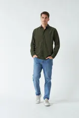 Camisa de pana color beige, de corte regular, con cuello clásico y cierre frontal con botones. Confeccionada en algodón.