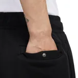 Pantalón de jogging negro con cintura elástica ajustable con cordón, corte holgado y logo Nike bordado en color naranja en la pierna izquierda.