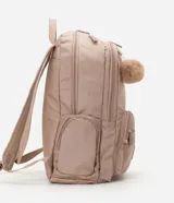 Mochila femenina color beige con textura acolchada y bolsillo frontal con cierre. Incluye asas largas ajustables, correa de mano y llavero de pompón.