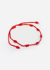 Pulsera roja de hilo con siete nudos.
