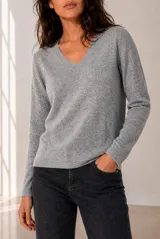 Sweater tejido de punto melange color bordó, con escote en V y mangas largas.