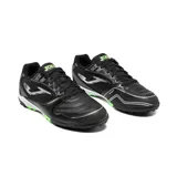 Championes de fútbol 5 Joma Dribling 2601 Black, de color negro con detalles en plateado y verde. Cuenta con upper de piel sintética y paneles de mesh transpirable, refuerzo en la puntera y suela multitaco de caucho con entresuela blanca.