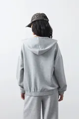 Campera con capucha gris Daniel Cassin, de diseño holgado, cierre frontal y bolsillos delanteros.