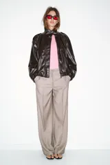 Pantalón de tiro alto con diseño de espiga, pernera recta y bolsillos frontales. Incluye un cinturón trenzado a tono y cierre frontal con cremallera, botón y gancho.