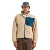 Campera de polar soft touch color beige, con cuello alto, cierre frontal completo, bolsillo superior de corderoy azul con cierre y detalles de ribetes azules.