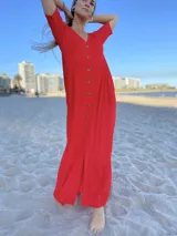 Vestido largo color rojo con botones frontales y mangas cortas.