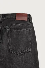 Jeans de corte recto en tono azul clásico con efecto lavado, tiro medio y diseño de cinco bolsillos con cierre frontal de botones.