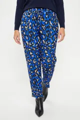 Pantalón de corte recto con estampado animal print en tonos azules, negros y beige. Presenta cintura elástica con lazo ajustable del mismo tejido y bolsillos laterales.