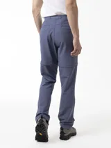 Pantalón Merrell desmontable de trekking color gris, de corte recto y tiro medio, confeccionado con tejido elástico de poliéster y spandex. Incluye cinturón ajustable, bolsillos laterales con cierre y logo reflectante.