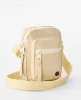 Morral Rip Curl Everyday Mini X Body de color natural, con bolsillo frontal con cierre, tira ajustable y detalles de la marca.