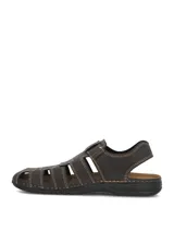 Sandalias de cuero color marrón oscuro con diseño tipo huarache o romano, costuras visibles en tono contrastante y cierre con tira ajustable de velcro en el empeine.