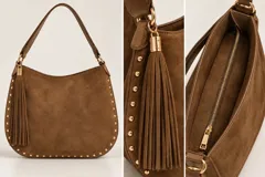 Cartera estilo hobo de color marrón con textura tipo gamuza, detalle de flecos colgantes y tachas doradas a lo largo de los bordes. Cuenta con asa para el hombro y herrajes metálicos dorados.