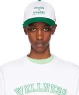 Gorro de béisbol blanco con visera verde y logo bordado en verde con la frase "Health is Wealth!".