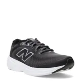 Championes de running New Balance modelo 411, color negro con suela blanca. Presentan diseño de malla transpirable, logo lateral característico y cierre con cordones.