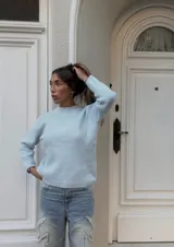 Sweater celeste de punto con cuello redondo y mangas largas.