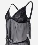 Conjunto de pijama tipo short doll compuesto por una blusa con escote en V y breteles regulables, y un short con cintura elástica. Ambas piezas están confeccionadas en tul transparente con delicados detalles de encaje en el escote y el ruedo.