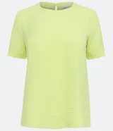 Blusa blanca de poliéster con cuello redondo, mangas cortas, cierre trasero en forma de gota, pequeñas aberturas laterales y acabados en pespuntes en las mangas y el cuello.