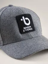 Gorra de béisbol de paño en color azul marino, con estructura de seis paneles y etiqueta pequeña con logo en el lateral.