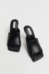 Sandalias Miista modelo Miri color negro, con punta cuadrada y taco acampanado transparente.