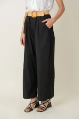 Pantalón ancho negro de algodón y spandex, con cintura elastizada, cinto rústico y bolsillos laterales.