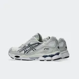 Championes Asics modelo Gel Nyc, en color blanco con detalles en gris claro y azul marino. Confeccionados con malla transpirable y superposiciones sintéticas, con tecnología GEL en la suela para mayor comodidad.