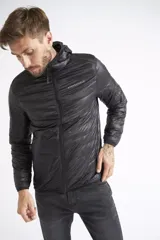 Campera de plumas liviana para hombre, con diseño acolchado, cierre frontal completo, capucha y bolsillos laterales. Presenta un logo estampado en el pecho.