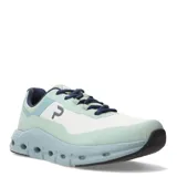 Championes deportivos unisex con diseño moderno, capellada de malla blanca y refuerzos en tono verde agua. Presenta mediasuela voluminosa de color celeste con orificios laterales para mayor amortiguación y cordones en azul marino.