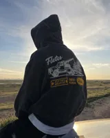 Hoodie de corte regular en color gris melange, con capucha, mangas largas y bolsillos tipo canguro. Presenta un estampado gráfico en la espalda con la inscripción 'Fletes' y una ilustración de una grúa transportando una planta.