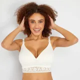 Sujetador de maternidad blanco con copas suaves, escote en V y banda inferior de encaje floral. Los tirantes son ajustables y tienen broches para facilitar la lactancia.