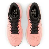 Championes de running New Balance 860 V13 para mujer, color rosa con detalles en negro y beige.