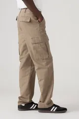 Pantalón cargo color marrón claro, de corte recto y holgado, con bolsillos laterales con solapa en las piernas.