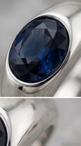 Anillo de plata con diseño de sello y cristal azul facetado en forma ovalada.