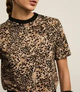Blusa de mangas cortas con estampado de leopardo y cuello redondo de punto contrastante.