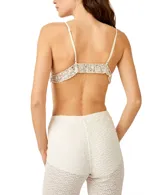 Sujetador tipo bralette color plateado, con lentejuelas y breteles finos regulables. Presenta un pequeño volado en el borde inferior.