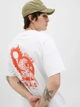 Remera blanca de algodón con cuello redondo y manga corta. Estampado en la espalda con un tigre, un sol y texto en color naranja.