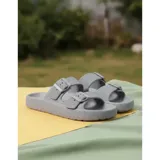 Sandalias chancletas de goma color beige con diseño texturizado en la suela, doble tira ajustable con hebillas y estilo slip-on.