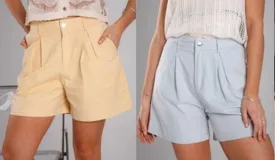 Short celeste de gabardina de algodón, tiro alto, corte amplio, pinzas frontales, bolsillos laterales, cierre y botón metálico.