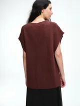 Chaleco de tejido de punto con lana y alpaca, de corte relajado y caída recta. Presenta laterales abiertos con cierre de botones y cuello redondo.