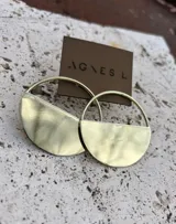 Aros de bronce y alpaca con diseño geométrico de medio círculo en la parte inferior y aro superior.