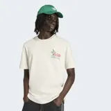 Remera blanca de algodón con cuello redondo y corte clásico. Presenta un pequeño estampado en el pecho que incluye la mascota Pique del Mundial México 86 y el logo de Adidas.