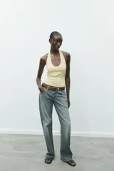 Top de punto con cuello halter y escote redondo profundo, sin mangas y corte ajustado.