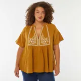 Blusa color mostaza de gasa de algodón con escote en V y bordado floral blanco en el frente.