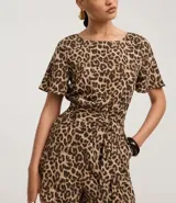 Enterito corto de mangas cortas con estampado de leopardo. Presenta cuello redondo con cierre tipo gota en la espalda, elástico en la cintura y lazo ajustable a juego.