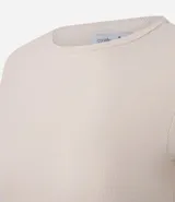 Blusa color beige de mangas cortas, confeccionada en tejido rib con textura acanalada y cuello redondo.