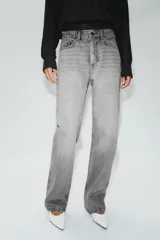 Jeans de tiro alto con cinco bolsillos, pernera recta y larga, confeccionados en denim negro con cierre frontal de cremallera y botón metálico.