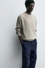 Jersey de punto con corte regular fit, cuello redondo y manga larga. Presenta un diseño de textura acanalada con acabados en rib en puños y bajo.