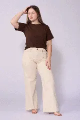 Jean de corte wide leg en color beige, con tiro alto y cierre frontal con botón y cremallera. Presenta un diseño de cinco bolsillos y costuras reforzadas.